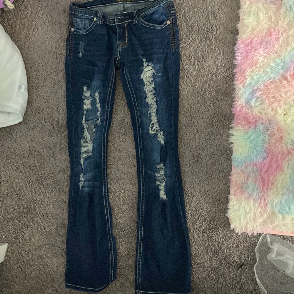 Women’s ripped, low rise, bootcut jeans.